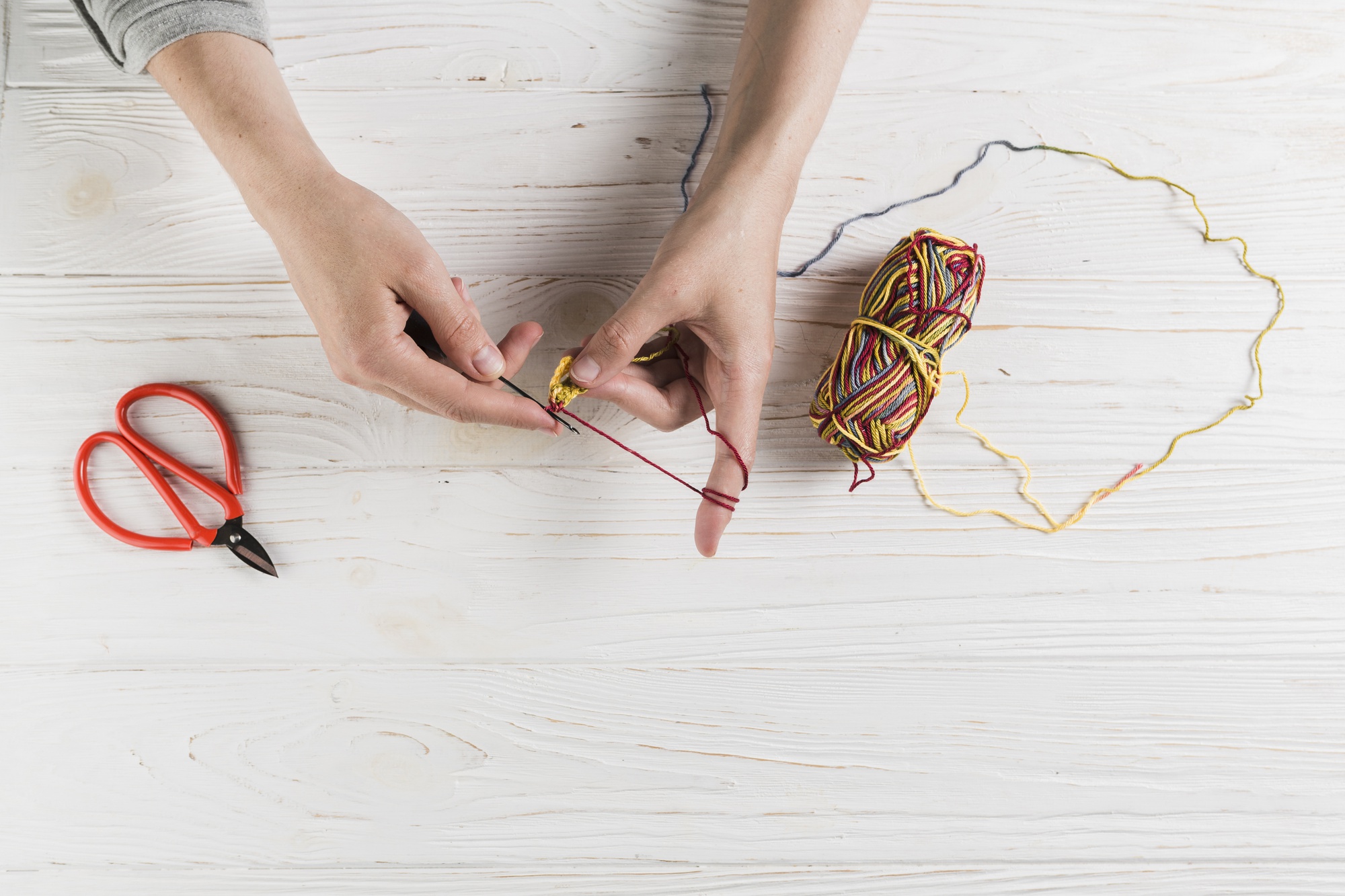 Hands arranging threads and needles